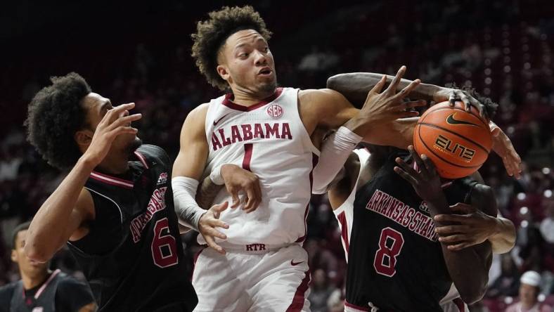 Dec 4, 2023; Tuscaloosa, Alabama, USA;  Arkansas State guard Taryn Todd (6), Alabama guard Mark Sears (1) and Arkansas State forward Lado Laku (8) fight to control a rebound at Coleman Coliseum. Mandatory Credit: Gary Cosby Jr.-USA TODAY Sports