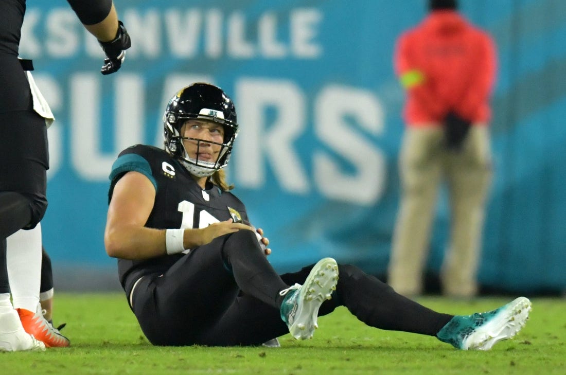 Jacksonville Jaguars quarterback Trevor Lawrence (16) looks up at a teammate after getting tackled by Cincinnati Bengals defensive end Sam Hubbard (94) late in the second quarter. The Jacksonville Jaguars hosted the Cincinnati Bengals at EverBank Stadium in Jacksonville, Florida for Monday Night Football, December 4, 2023. The Jaguars were tied 14 to 14 at the end of the first half. [Bob Self/Florida Times-Union]