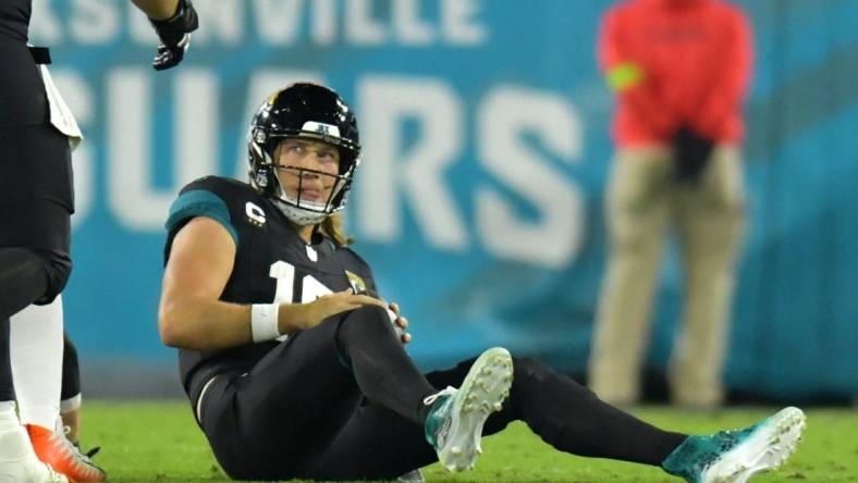 Jacksonville Jaguars quarterback Trevor Lawrence (16) looks up at a teammate after getting tackled by Cincinnati Bengals defensive end Sam Hubbard (94) late in the second quarter. The Jacksonville Jaguars hosted the Cincinnati Bengals at EverBank Stadium in Jacksonville, Florida for Monday Night Football, December 4, 2023. The Jaguars were tied 14 to 14 at the end of the first half. [Bob Self/Florida Times-Union]