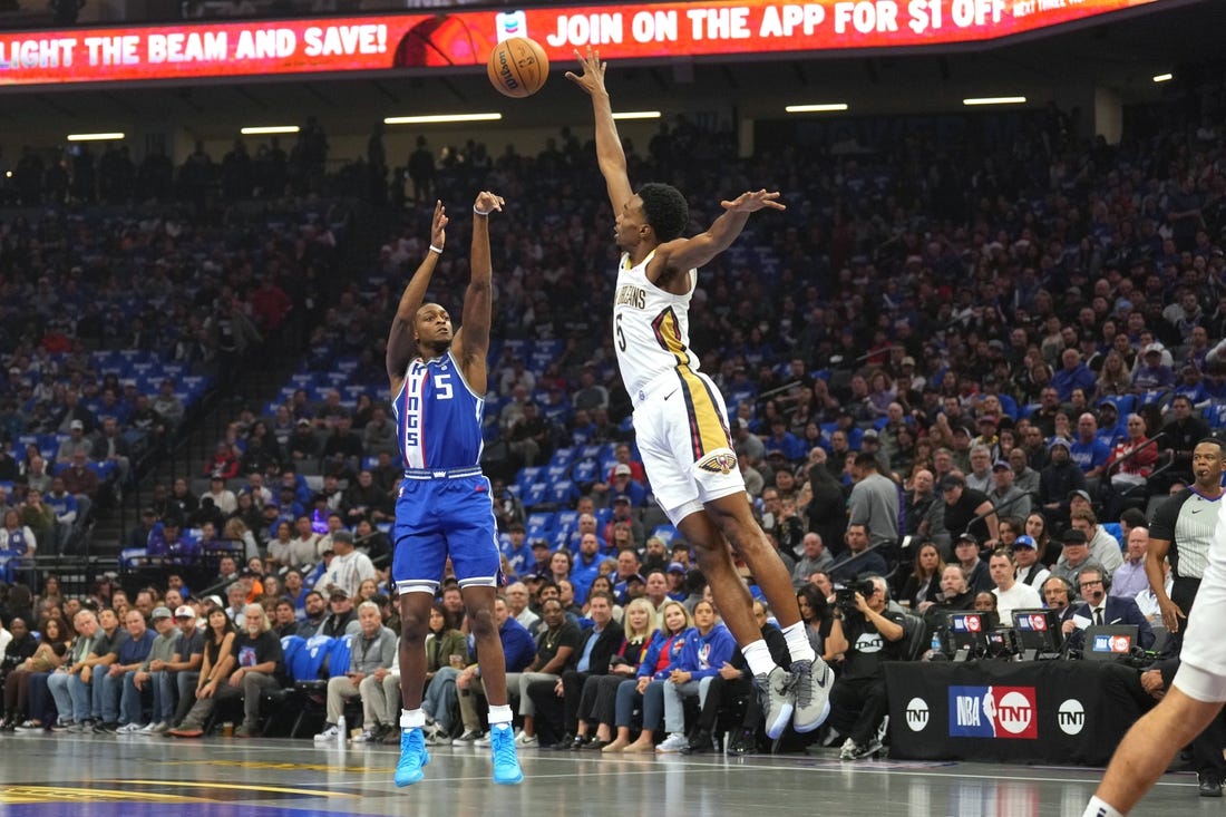 Dec 4, 2023; Sacramento, California, USA; Sacramento Kings guard De'Aaron Fox (5) shoots against New Orleans Pelicans forward Herbert Jones (5) during the first quarter at Golden 1 Center. Mandatory Credit: Darren Yamashita-USA TODAY Sports