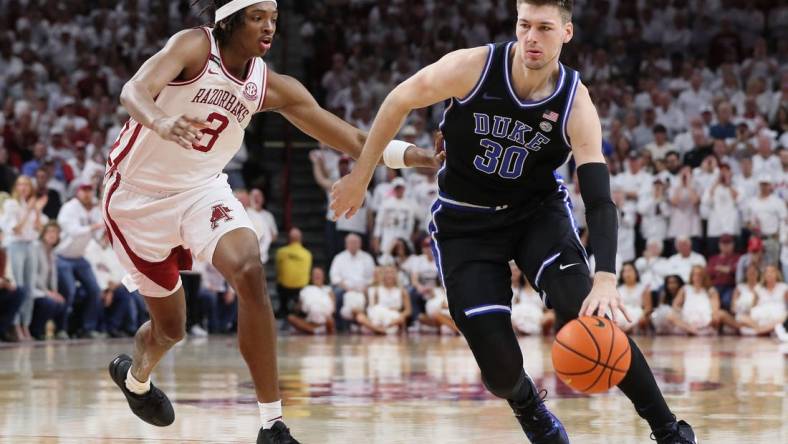 Nov 29, 2023; Fayetteville, Arkansas, USA; Duke Blue Devils center Kyle Filipowski (30) during the first half as Arkansas Razorbacks Chandler Lawson (8) defends at Bud Walton Arena. Arkansas won 80-75. Mandatory Credit: Nelson Chenault-USA TODAY Sports