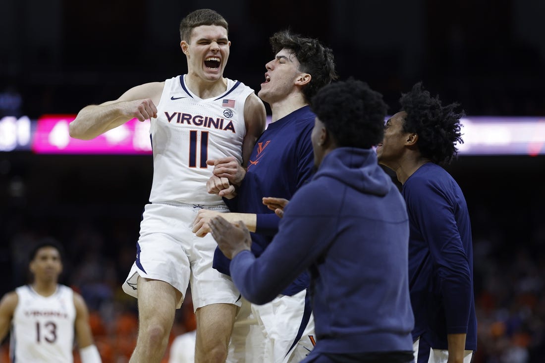 Dec 5, 2023; Charlottesville, Virginia, USA; Virginia Cavaliers guard Isaac McKneely (11) celebrates with teammates against the North Carolina Central Eagles in the first half at John Paul Jones Arena. Mandatory Credit: Geoff Burke-USA TODAY Sports