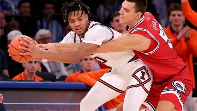 Dec 5, 2023; New York, New York, USA; Illinois Fighting Illini guard Terrence Shannon Jr. (0) is fouled by Florida Atlantic Owls center Vladislav Goldin (50) during the second half at Madison Square Garden. Mandatory Credit: Brad Penner-USA TODAY Sports