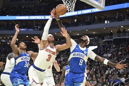 Dec 5, 2023; Milwaukee, Wisconsin, USA; New York Knicks guard Josh Hart (3) and Milwaukee Bucks forward Bobby Portis (9) battle for a rebound in the first half at Fiserv Forum. Mandatory Credit: Michael McLoone-USA TODAY Sports