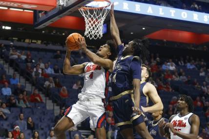 Dec 5, 2023; Oxford, Mississippi, USA; Mississippi Rebels forward Jaemyn Brakefield (4) drives to the basket as Mount St. Mary's Mountaineers forward Dola Adebayo (4) defends during the first half at The Sandy and John Black Pavilion at Ole Miss. Mandatory Credit: Petre Thomas-USA TODAY Sports
