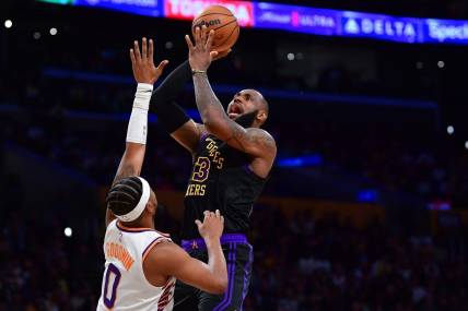 Dec 5, 2023; Los Angeles, California, USA; Los Angeles Lakers forward LeBron James (23) shoots against Phoenix Suns guard Jordan Goodwin (0) during the first half of the In Season Tournament quarterfinal at Crypto.com Arena. Mandatory Credit: Gary A. Vasquez-USA TODAY Sports