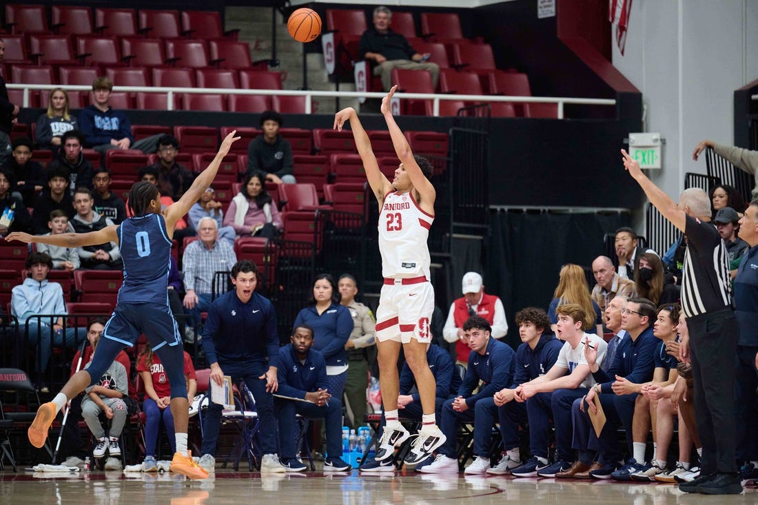 Dec 3, 2023; Stanford, California, USA; Stanford Cardinal forward Brandon Angel (23) shoots the ball against San Diego Toreros guard Kevin Patton Jr. (0) during the first half at Maples Pavilion. Mandatory Credit: Robert Edwards-USA TODAY Sports