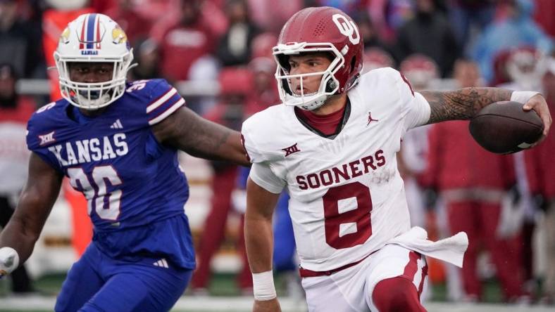 Oct 28, 2023; Lawrence, Kansas, USA; Oklahoma Sooners quarterback Dillon Gabriel (8) runs the ball as Kansas Jayhawks linebacker Rich Miller (30) defends during the game at David Booth Kansas Memorial Stadium. Mandatory Credit: Denny Medley-USA TODAY Sports