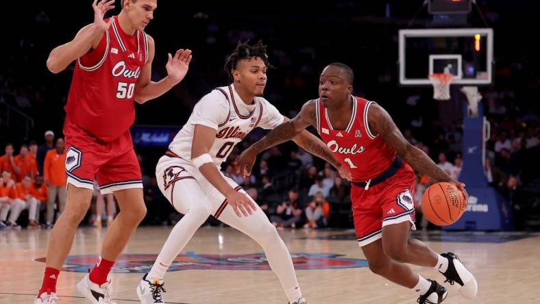 Dec 5, 2023; New York, New York, USA; Florida Atlantic Owls guard Johnell Davis (1) drives to the basket against Illinois Fighting Illini guard Terrence Shannon Jr. (0) in front of Owls center Vladislav Goldin (50) during the second half at Madison Square Garden. Mandatory Credit: Brad Penner-USA TODAY Sports