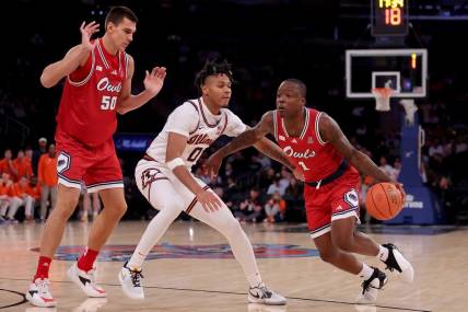 Dec 5, 2023; New York, New York, USA; Florida Atlantic Owls guard Johnell Davis (1) drives to the basket against Illinois Fighting Illini guard Terrence Shannon Jr. (0) in front of Owls center Vladislav Goldin (50) during the second half at Madison Square Garden. Mandatory Credit: Brad Penner-USA TODAY Sports
