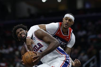 Dec 6, 2023; Washington, District of Columbia, USA; Philadelphia 76ers center Joel Embiid (21) is fouled by Washington Wizards center Daniel Gafford (21) in the second quarter at Capital One Arena. Mandatory Credit: Geoff Burke-USA TODAY Sports