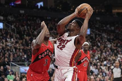 Dec 6, 2023; Toronto, Ontario, CAN; Miami Heat forward Jimmy Butler (22) tries to make a basket against Toronto Raptors forward O.G. Anunoby (3) during the first half at Scotiabank Arena. Mandatory Credit: John E. Sokolowski-USA TODAY Sports