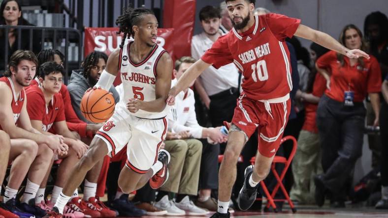 Dec 6, 2023; Queens, New York, USA; St. John's Red Storm guard Daniss Jenkins (5) drives past Sacred Heart Pioneers guard Kyle McGee (10) in the first half at Carnesecca Arena. Mandatory Credit: Wendell Cruz-USA TODAY Sports