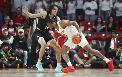 Dec 6, 2023; Houston, Texas, USA; Houston Cougars forward J'Wan Roberts (13) drives with the ball as Rice Owls forward Keanu Dawes (24) defends during the first half at Fertitta Center. Mandatory Credit: Troy Taormina-USA TODAY Sports