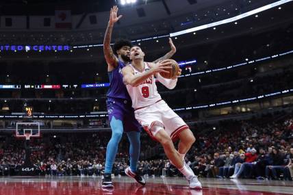 Dec 6, 2023; Chicago, Illinois, USA; Chicago Bulls center Nikola Vucevic (9) drives to the basket against Charlotte Hornets center Nick Richards (4) during the first half at United Center. Mandatory Credit: Kamil Krzaczynski-USA TODAY Sports