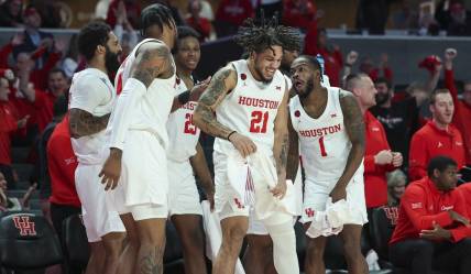 Dec 6, 2023; Houston, Texas, USA; Houston Cougars guard Emanuel Sharp (21) celebrates with teammates after a play during the second half against the Rice Owls at Fertitta Center. Mandatory Credit: Troy Taormina-USA TODAY Sports