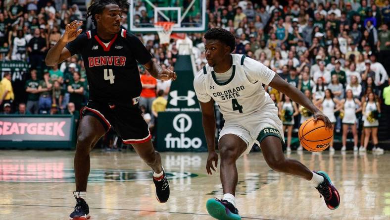 Dec 6, 2023; Fort Collins, Colorado, USA; Colorado State Rams guard Isaiah Stevens (4) controls the ball as Denver Pioneers guard DeAndre Craig (4) guards in the second half at Moby Arena. Mandatory Credit: Isaiah J. Downing-USA TODAY Sports