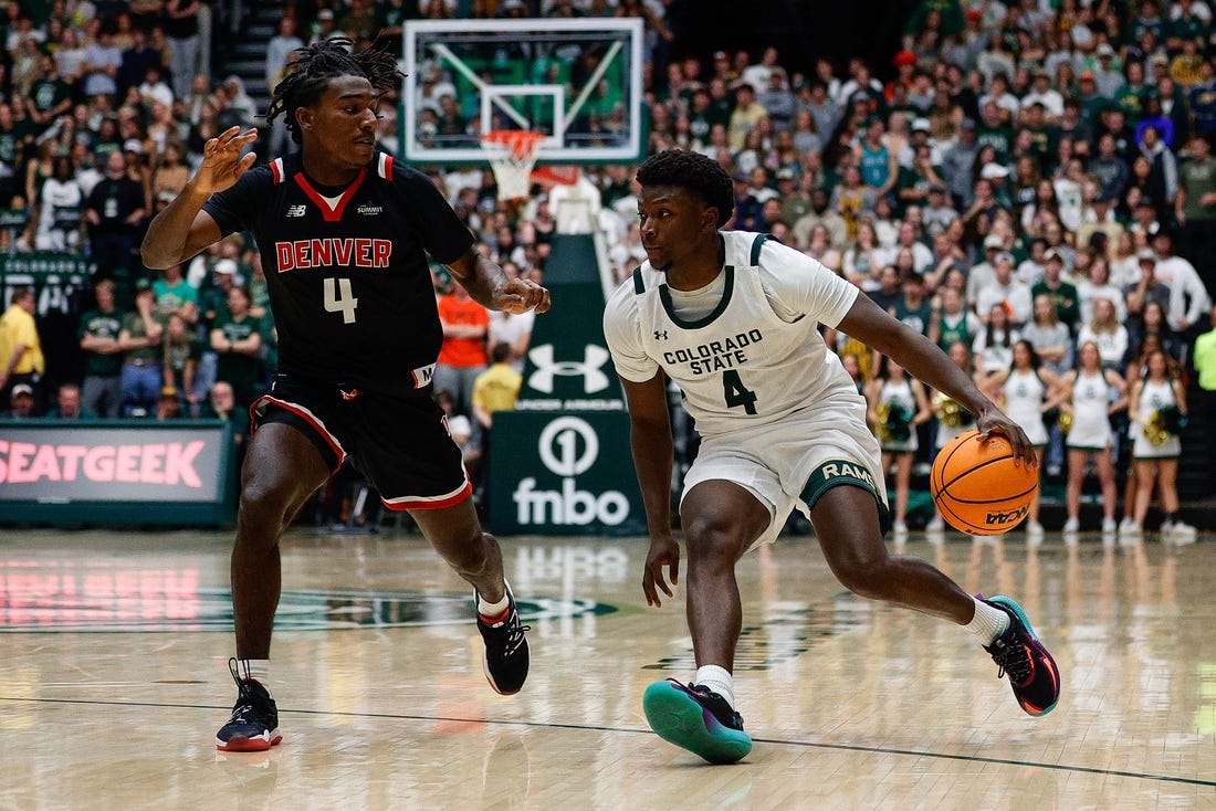 Dec 6, 2023; Fort Collins, Colorado, USA; Colorado State Rams guard Isaiah Stevens (4) controls the ball as Denver Pioneers guard DeAndre Craig (4) guards in the second half at Moby Arena. Mandatory Credit: Isaiah J. Downing-USA TODAY Sports