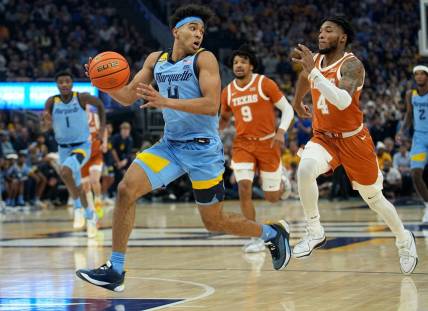 Dec 6, 2023; Milwaukee, Wisconsin, USA;  Marquette guard Stevie Mitchell (4)  gets past Texas guard Tyrese Hunter (4) on a fast break during the first half of their game at Fiserv Forum. Mandatory Credit: Jeff Hanisch-USA TODAY Sports
