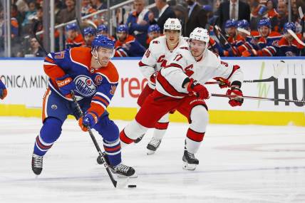 Dec 6, 2023; Edmonton, Alberta, CAN; Edmonton Oilers forward Connor McDavid (97) looks to make a pass in front of Carolina Hurricanes forward Andrei Svechnikov (37) during the third period at Rogers Place. Mandatory Credit: Perry Nelson-USA TODAY Sports