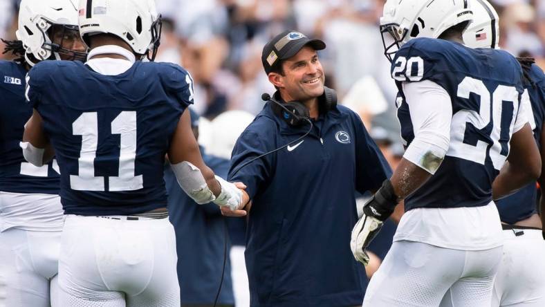 Penn State defensive coordinator Manny Diaz grins as his unit comes to the sideline after creating a turnover late in the the second half of an NCAA football game against Indiana at Beaver Stadium Saturday, Oct. 28, 2023, in State College, Pa.