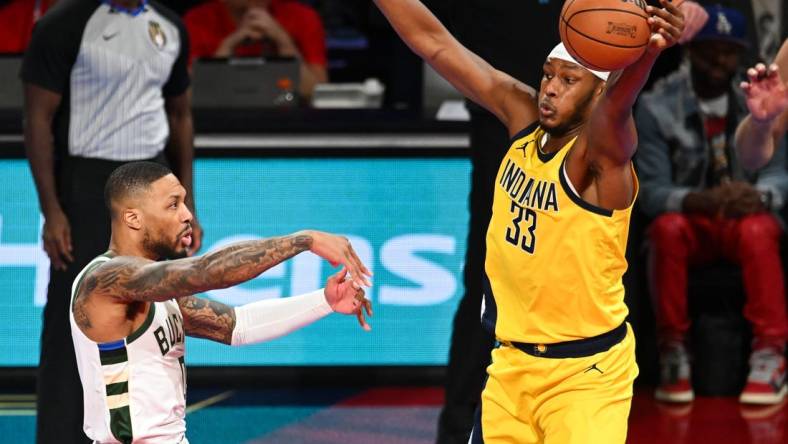 Dec 7, 2023; Las Vegas, Nevada, USA; Indiana Pacers center Myles Turner (33) gets a hand on a pass by Milwaukee Bucks guard Damian Lillard (0) during the first quarter at T-Mobile Arena. Mandatory Credit: Candice Ward-USA TODAY Sports