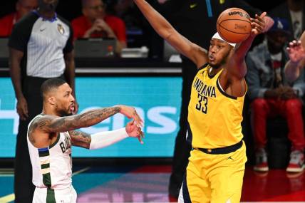 Dec 7, 2023; Las Vegas, Nevada, USA; Indiana Pacers center Myles Turner (33) gets a hand on a pass by Milwaukee Bucks guard Damian Lillard (0) during the first quarter at T-Mobile Arena. Mandatory Credit: Candice Ward-USA TODAY Sports