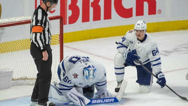 Dec 7, 2023; Ottawa, Ontario, CAN; Toronto Maple Leafs goalie Joseph Woll (60) is injured on a play in the third period against the  Ottawa Senators at the Canadian Tire Centre. Mandatory Credit: Marc DesRosiers-USA TODAY Sports