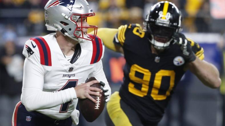 Dec 7, 2023; Pittsburgh, Pennsylvania, USA;  New England Patriots quarterback Bailey Zappe (4) runs the ball as Pittsburgh Steelers linebacker T.J. Watt (90) chases during the third quarter at Acrisure Stadium. New England won 21-18. Mandatory Credit: Charles LeClaire-USA TODAY Sports