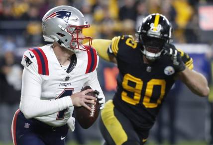 Dec 7, 2023; Pittsburgh, Pennsylvania, USA;  New England Patriots quarterback Bailey Zappe (4) runs the ball as Pittsburgh Steelers linebacker T.J. Watt (90) chases during the third quarter at Acrisure Stadium. New England won 21-18. Mandatory Credit: Charles LeClaire-USA TODAY Sports