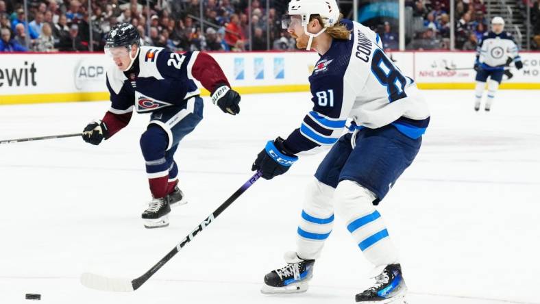 Dec 7, 2023; Denver, Colorado, USA; Winnipeg Jets left wing Kyle Connor (81) shoots the puck in the second period against the Colorado Avalanche at Ball Arena. Mandatory Credit: Ron Chenoy-USA TODAY Sports