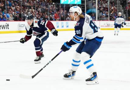 Dec 7, 2023; Denver, Colorado, USA; Winnipeg Jets left wing Kyle Connor (81) shoots the puck in the second period against the Colorado Avalanche at Ball Arena. Mandatory Credit: Ron Chenoy-USA TODAY Sports