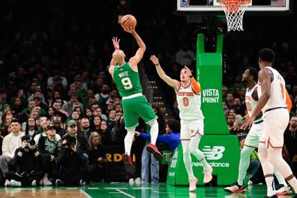 Dec 8, 2023; Boston, Massachusetts, USA;  Boston Celtics guard Derrick White (9) shoots over New York Knicks guard Donte DiVincenzo (0) during the first half at TD Garden. Mandatory Credit: Eric Canha-USA TODAY Sports