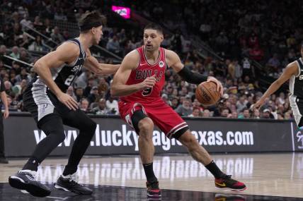 Dec 8, 2023; San Antonio, Texas, USA;  Chicago Bulls center Nikola Vucevic (9) moves against San Antonio Spurs forward Zach Collins (23) in the first half at the Frost Bank Center. Mandatory Credit: Daniel Dunn-USA TODAY Sports