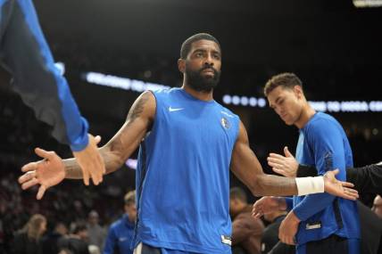 Dec 8, 2023; Portland, Oregon, USA; Dallas Mavericks point guard Kyrie Irving (11) is introduced as part of the starting lineup before the game against the Portland Trail Blazers at Moda Center. Mandatory Credit: Soobum Im-USA TODAY Sports