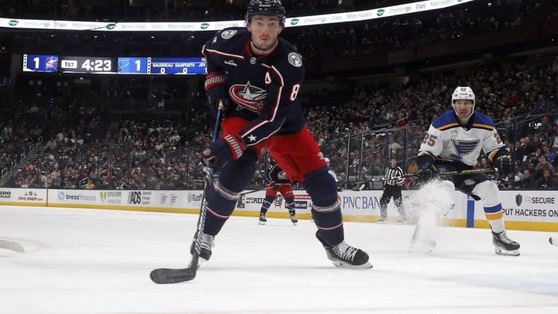 Dec 8, 2023; Columbus, Ohio, USA; Columbus Blue Jackets defenseman Zach Werenski (8) tracks down a loose puck against the St. Louis Blues during the first period at Nationwide Arena. Mandatory Credit: Russell LaBounty-USA TODAY Sports