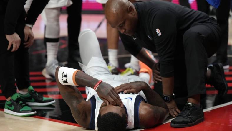 Dec 8, 2023; Portland, Oregon, USA; Dallas Mavericks point guard Kyrie Irving (11) is checked by a staff member during the first half against the Portland Trail Blazers at Moda Center. Mandatory Credit: Soobum Im-USA TODAY Sports