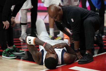 Dec 8, 2023; Portland, Oregon, USA; Dallas Mavericks point guard Kyrie Irving (11) is checked by a staff member during the first half against the Portland Trail Blazers at Moda Center. Mandatory Credit: Soobum Im-USA TODAY Sports