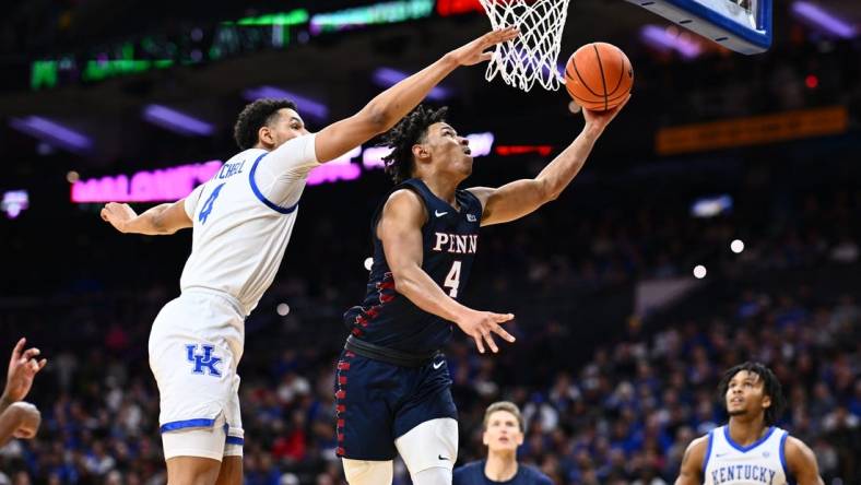 Dec 9, 2023; Philadelphia, Pennsylvania, USA; Penn Quakers guard Tyler Perkins (4) shoots the ball against Kentucky Wildcats forward Tre Mitchell (4) in the first half at Wells Fargo Center. Mandatory Credit: Kyle Ross-USA TODAY Sports