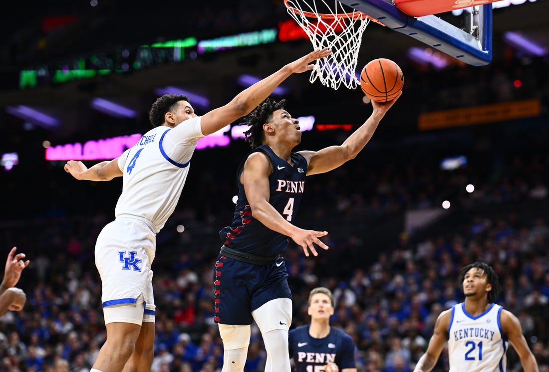 Dec 9, 2023; Philadelphia, Pennsylvania, USA; Penn Quakers guard Tyler Perkins (4) shoots the ball against Kentucky Wildcats forward Tre Mitchell (4) in the first half at Wells Fargo Center. Mandatory Credit: Kyle Ross-USA TODAY Sports