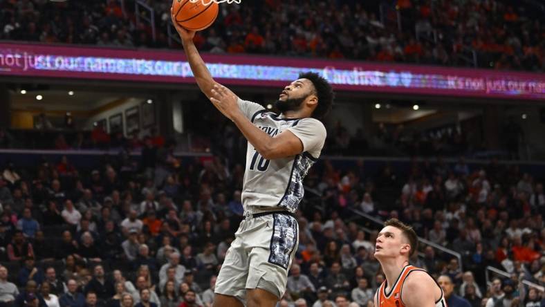 Dec 9, 2023; Washington, District of Columbia, USA; Georgetown Hoyas guard Jayden Epps (10) shoots as Syracuse Orange center Naheem McLeod (10) looks on during the second half at Capital One Arena. Mandatory Credit: Brad Mills-USA TODAY Sports