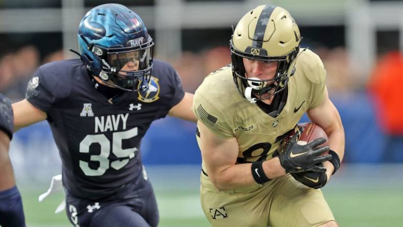 Dec 9, 2023; Foxborough, Massachusetts, USA; Army Black Knights wide receiver Casey Reynolds (87) is chased by Navy Midshipmen safety Kush'i Abraham (35) during the first half of the Army-Navy Game at Gillette Stadium. Mandatory Credit: Danny Wild-USA TODAY Sports