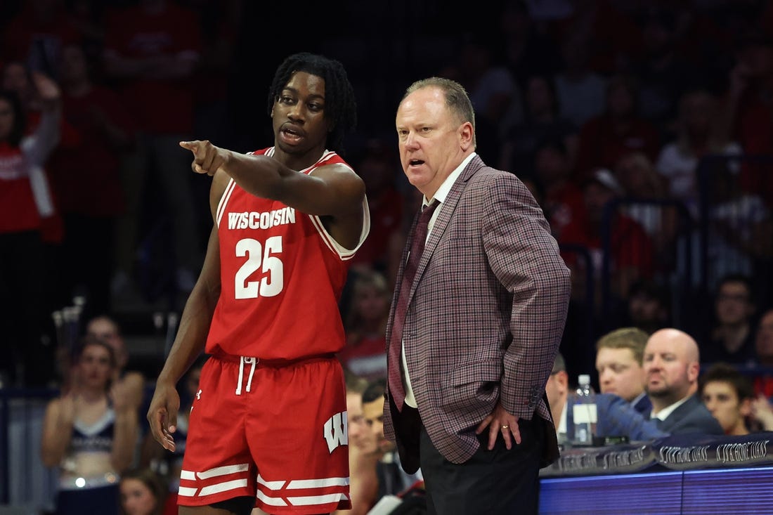 Dec 9, 2023; Tucson, Arizona, USA; Wisconsin Badgers guard John Blackwell (25) talks to Wisconsin Badgers head coach Greg Gard during the second half at McKale Center. Mandatory Credit: Zachary BonDurant-USA TODAY Sports