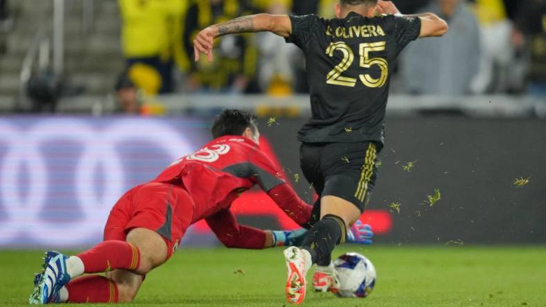 Dec 9, 2023; Columbus, OH, USA; Columbus Crew goalkeeper Patrick Schulte (28) makes a save against Los Angeles FC forward Cristian Olivera (25) during the second half in the 2023 MLS Cup championship game at Lower.com Field. Mandatory Credit: Aaron Doster-USA TODAY Sports