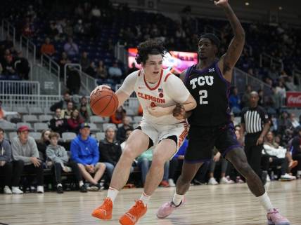 Dec 9, 2023; Toronto, Ontario, CAN; Clemson Tigers forward Ian Schieffelin (4) drives to the net against TCU Horned Frogs forward Emanuel Miller (2) during the second half at Coca-Cola Coliseum. Mandatory Credit: John E. Sokolowski-USA TODAY Sports
