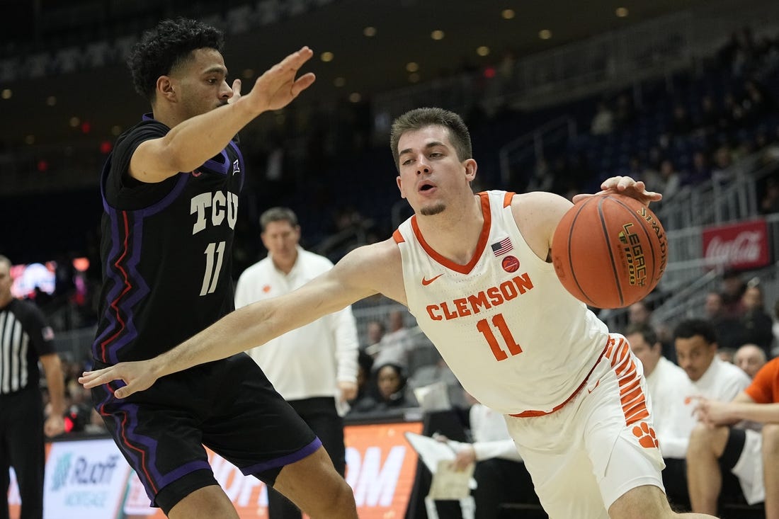 Dec 9, 2023; Toronto, Ontario, CAN; Clemson Tigers guard Joseph Girard III (11) drives against TCU Horned Frogs guard Trevian Tennyson (11) during the second half at Coca-Cola Coliseum. Mandatory Credit: John E. Sokolowski-USA TODAY Sports