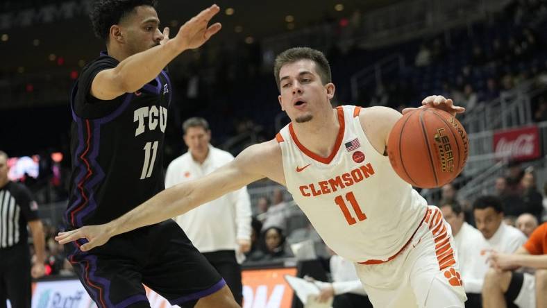 Dec 9, 2023; Toronto, Ontario, CAN; Clemson Tigers guard Joseph Girard III (11) drives against TCU Horned Frogs guard Trevian Tennyson (11) during the second half at Coca-Cola Coliseum. Mandatory Credit: John E. Sokolowski-USA TODAY Sports