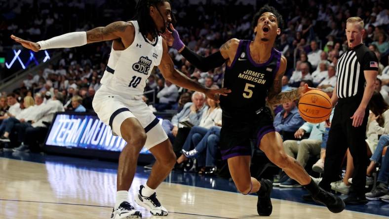 Dec 9, 2023; Norfolk, Virginia, USA; James Madison Dukes guard Terrence Edwards (5) drives to the basket against Old Dominion Monarchs guard Tyrone Williams (10) at Chartway Arena at the Ted Constant Convocation Center. Mandatory Credit: Peter Casey-USA TODAY Sports