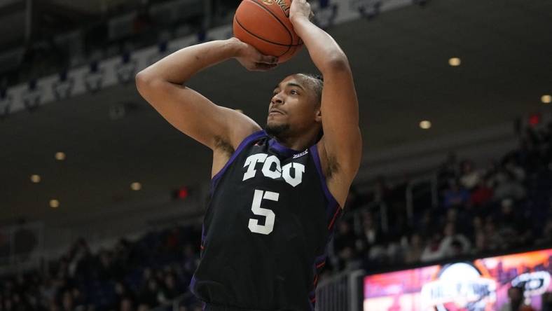 Dec 9, 2023; Toronto, Ontario, CAN; TCU Horned Frogs forward Chuck O'Bannon Jr. (5) goes to shoot a basket against Clemson Tigers during the first half at Coca-Cola Coliseum. Mandatory Credit: John E. Sokolowski-USA TODAY Sports