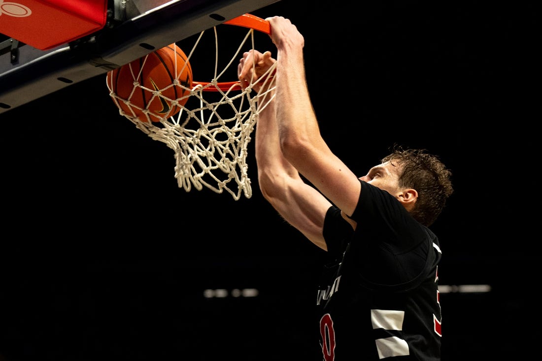 Cincinnati Bearcats forward Viktor Lakhin (30) dunks in the second half of the NCAA Basketball game between the Cincinnati Bearcats and Xavier Musketeers at the Cintas Center in Cincinnati on Saturday, Dec. 9, 2023.